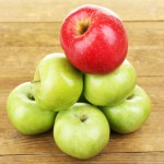 Juicy apples on wooden table